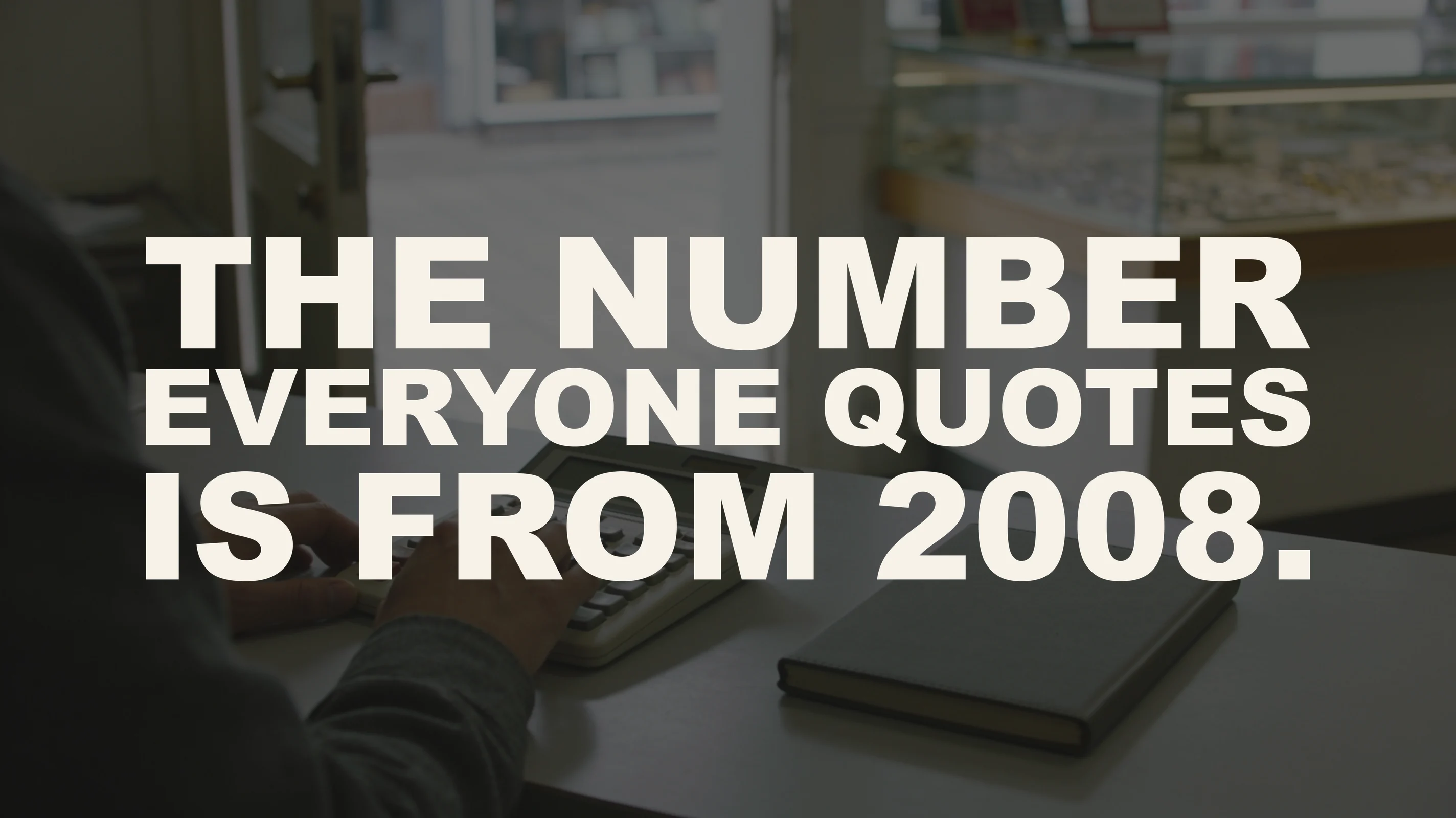 The words “The number everyone quotes is from 2008.” set in large type over a photograph taken in the back office of an independent jewelry store — one person’s hand rests on the keys of a plain desktop calculator beside a closed notebook, with the shop floor, its glass display cases and an open door full of overcast daylight softly out of focus behind.